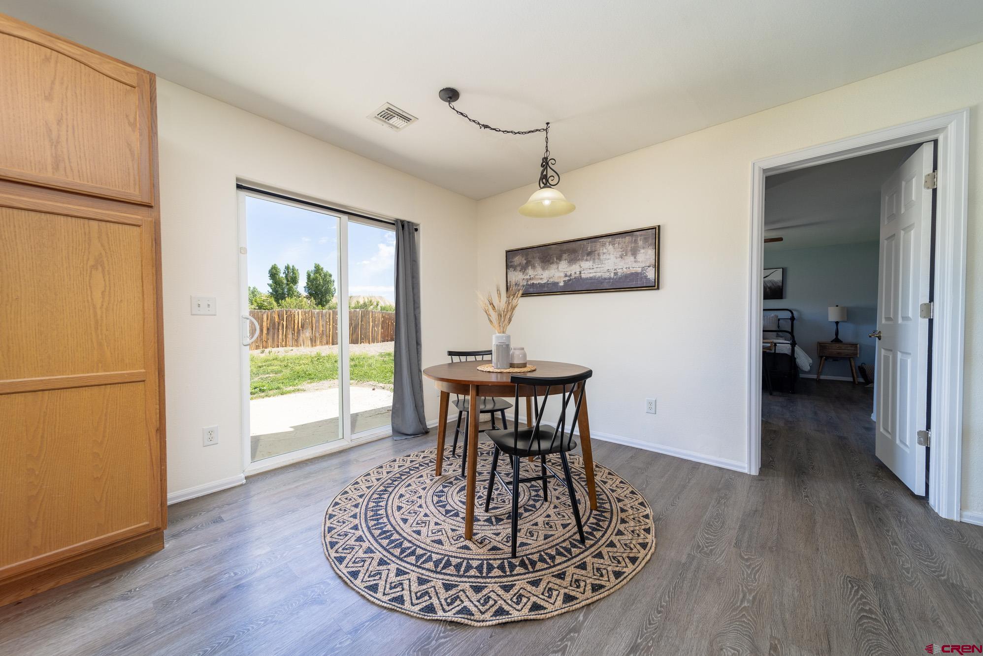 1531 Haystack Road Montrose, CO 81401 - Photo 9 of 34 a view of a livingroom with furniture a ceiling fan and wooden floor