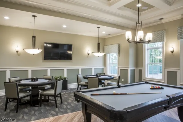 a room with furniture pool table and flat screen tv