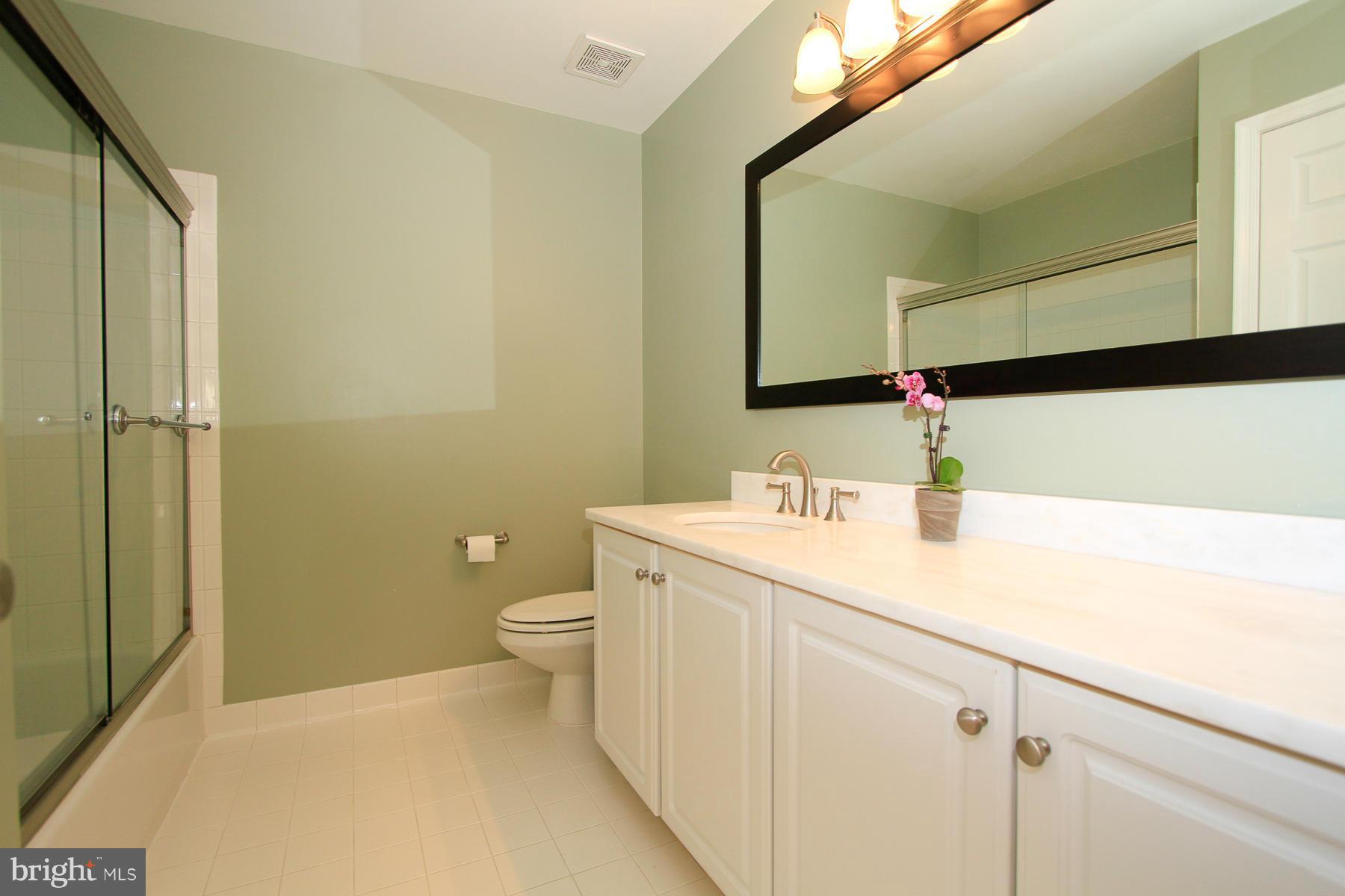 1304 Pavilion Club Way Reston, VA 20194 - Photo 21 of 30 a bathroom with a sink and a mirror