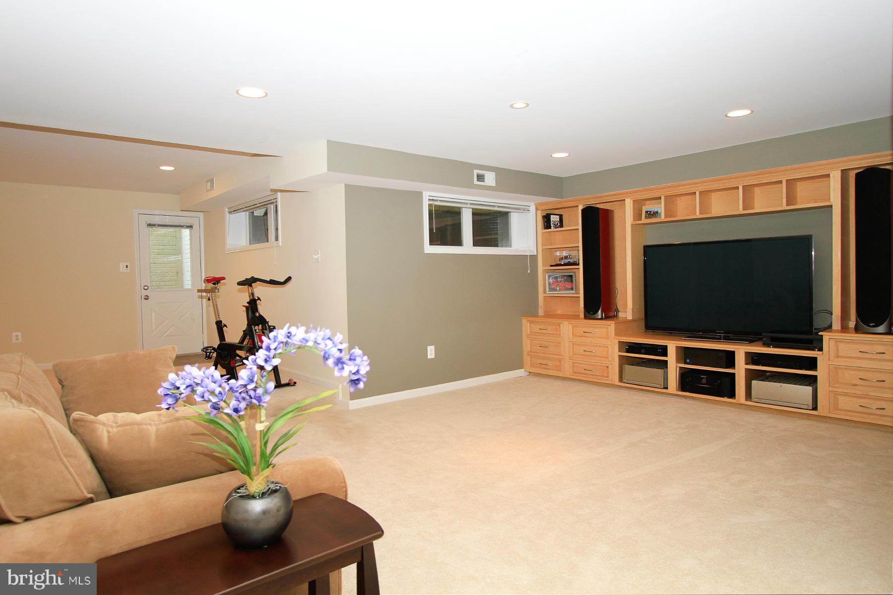 1304 Pavilion Club Way Reston, VA 20194 - Photo 23 of 30 a living room with furniture and a flat screen tv