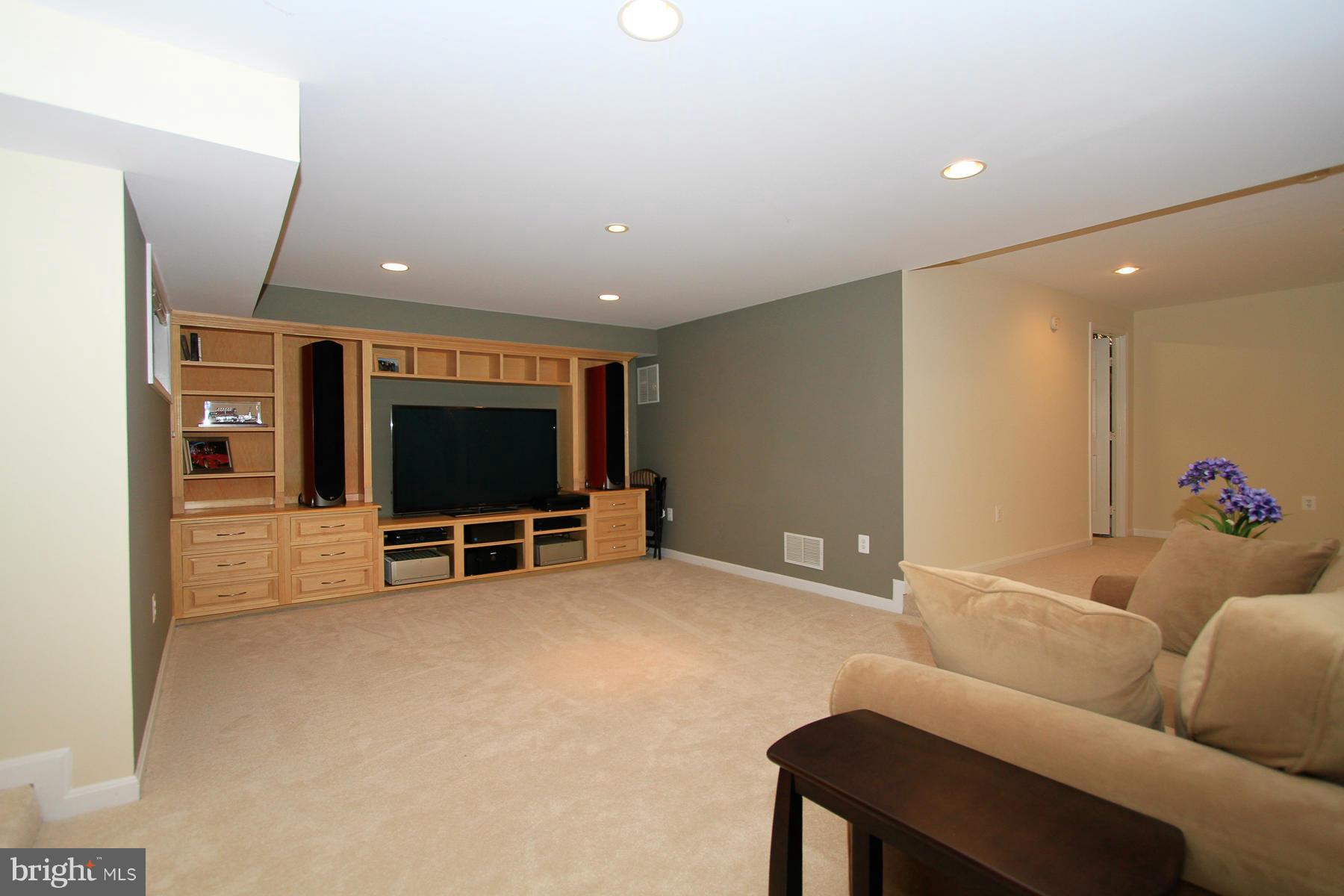 1304 Pavilion Club Way Reston, VA 20194 - Photo 24 of 30 a living room with furniture and a flat screen tv