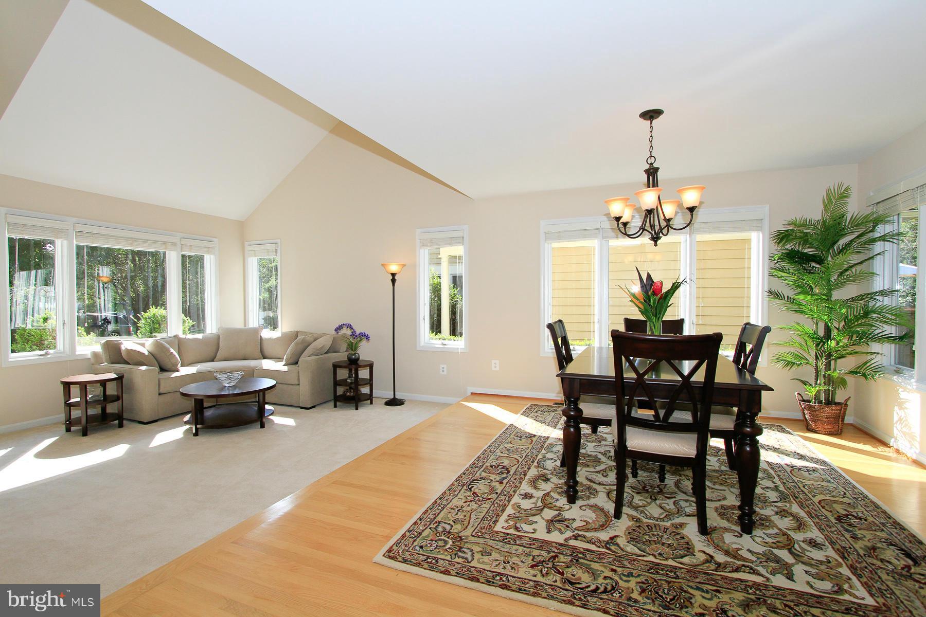 1304 Pavilion Club Way Reston, VA 20194 - Photo 6 of 30 a living room with furniture wooden floor and a chandelier