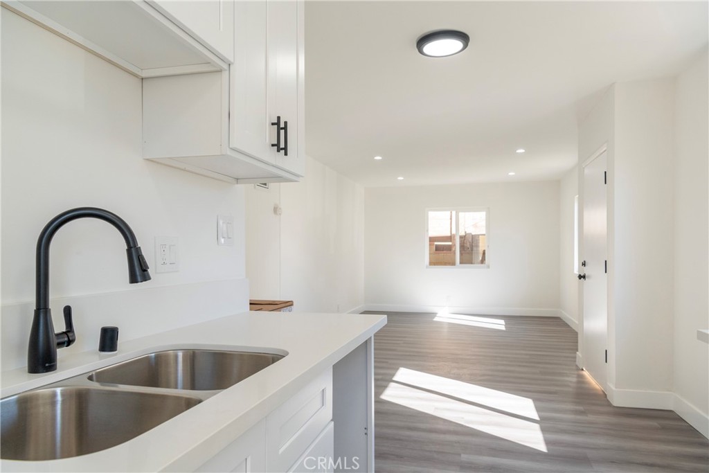 2107 Pullman Lane Redondo Beach, CA 90278 - Photo 11 of 16 a kitchen with stainless steel appliances kitchen island a sink a stove and a refrigerator with wooden floor