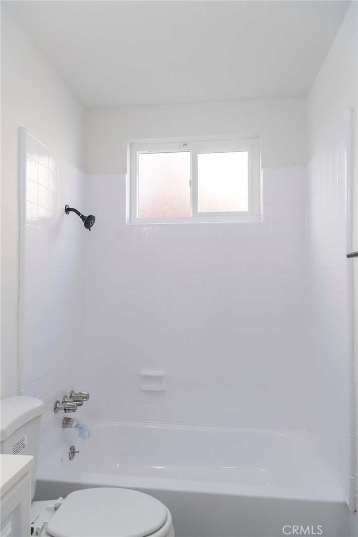 2107 Pullman Lane Redondo Beach, CA 90278 - Photo 13 of 16 a bathroom with a toilet a sink a window and mirror