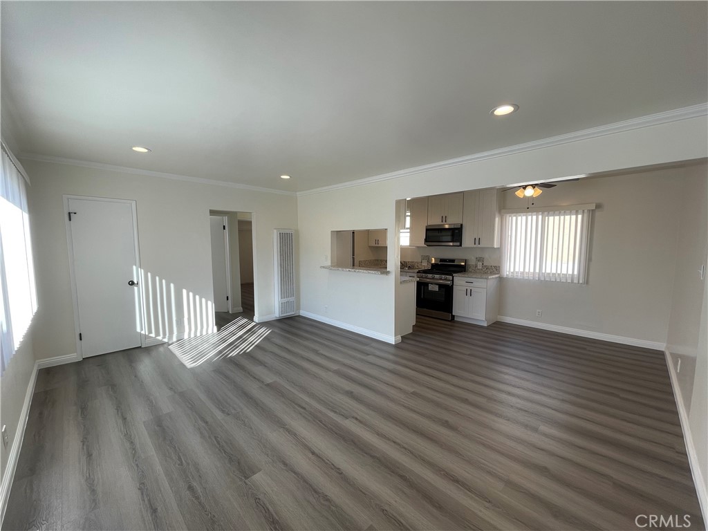 2107 Pullman Lane Redondo Beach, CA 90278 - Photo 5 of 16 an empty room with wooden floor and fireplace