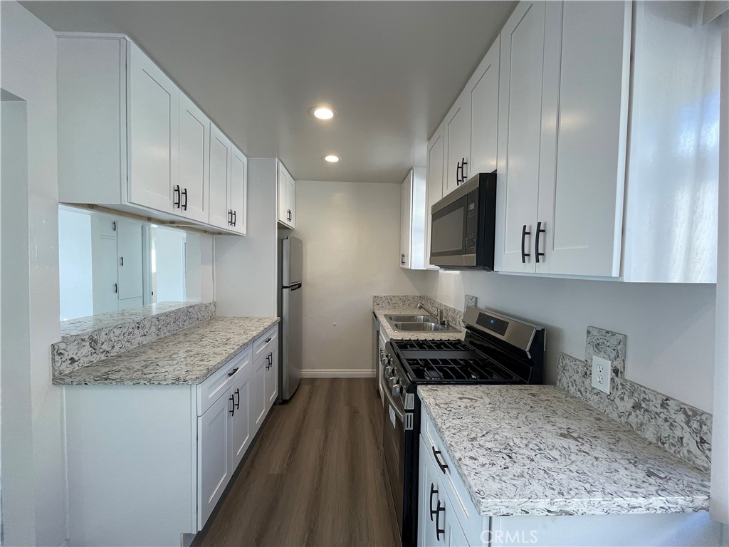 2107 Pullman Lane Redondo Beach, CA 90278 - Photo 8 of 16 a kitchen with stainless steel appliances granite countertop a sink stove and refrigerator