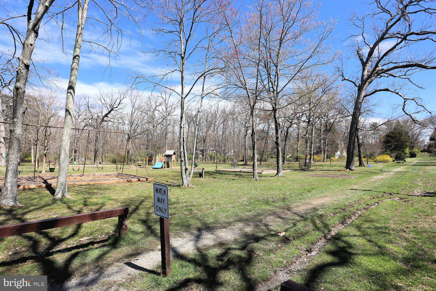 16 Maple Avenue Washington Grove, MD 20880 - Photo 46 of 58 Tranquil park path under blue skies.