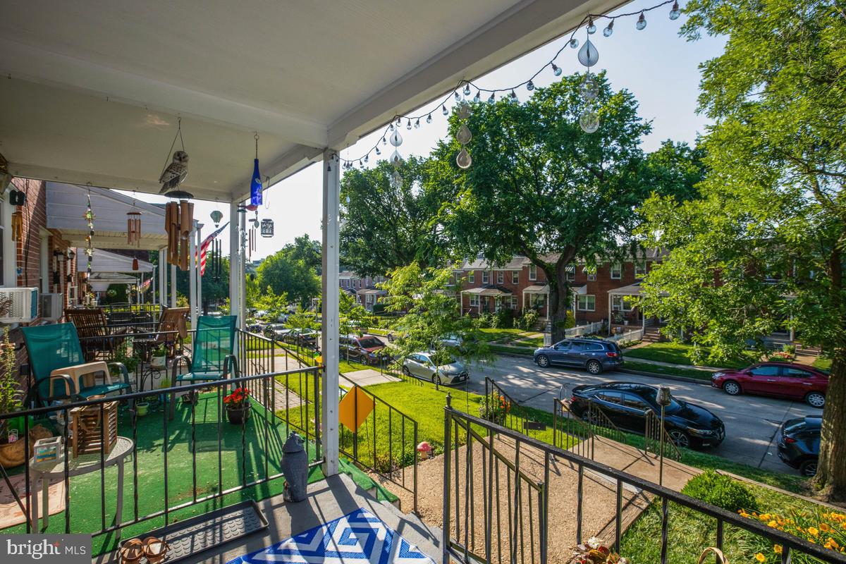 3574 Benzinger Road Baltimore, MD 21229 - Photo 3 of 29 Charming porch with vibrant street view.