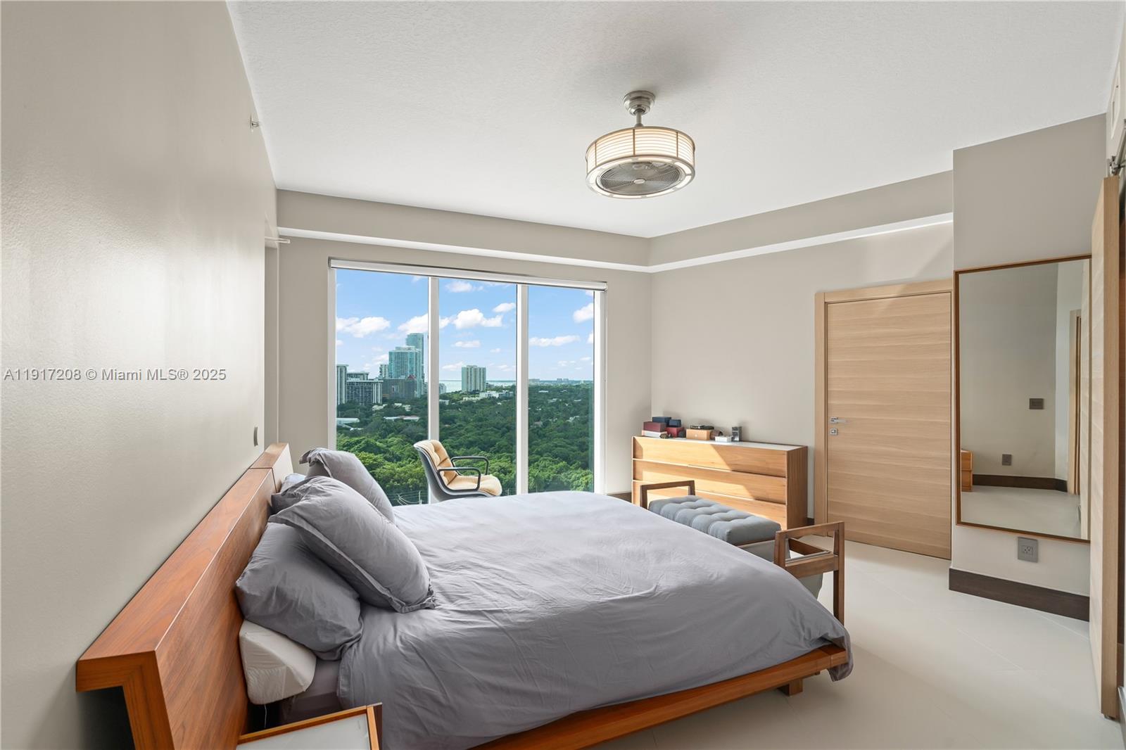 60 Southwest 13th Street, Unit 1400 Miami, FL 33130 - Photo 13 of 46 a bedroom with a bed and a large window