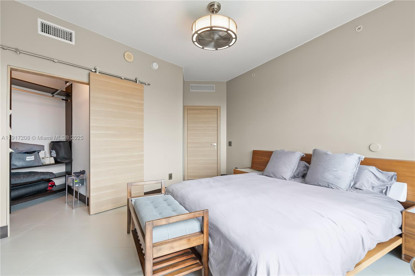 60 Southwest 13th Street, Unit 1400 Miami, FL 33130 - Photo 15 of 46 a bedroom with a bed and gym equipment