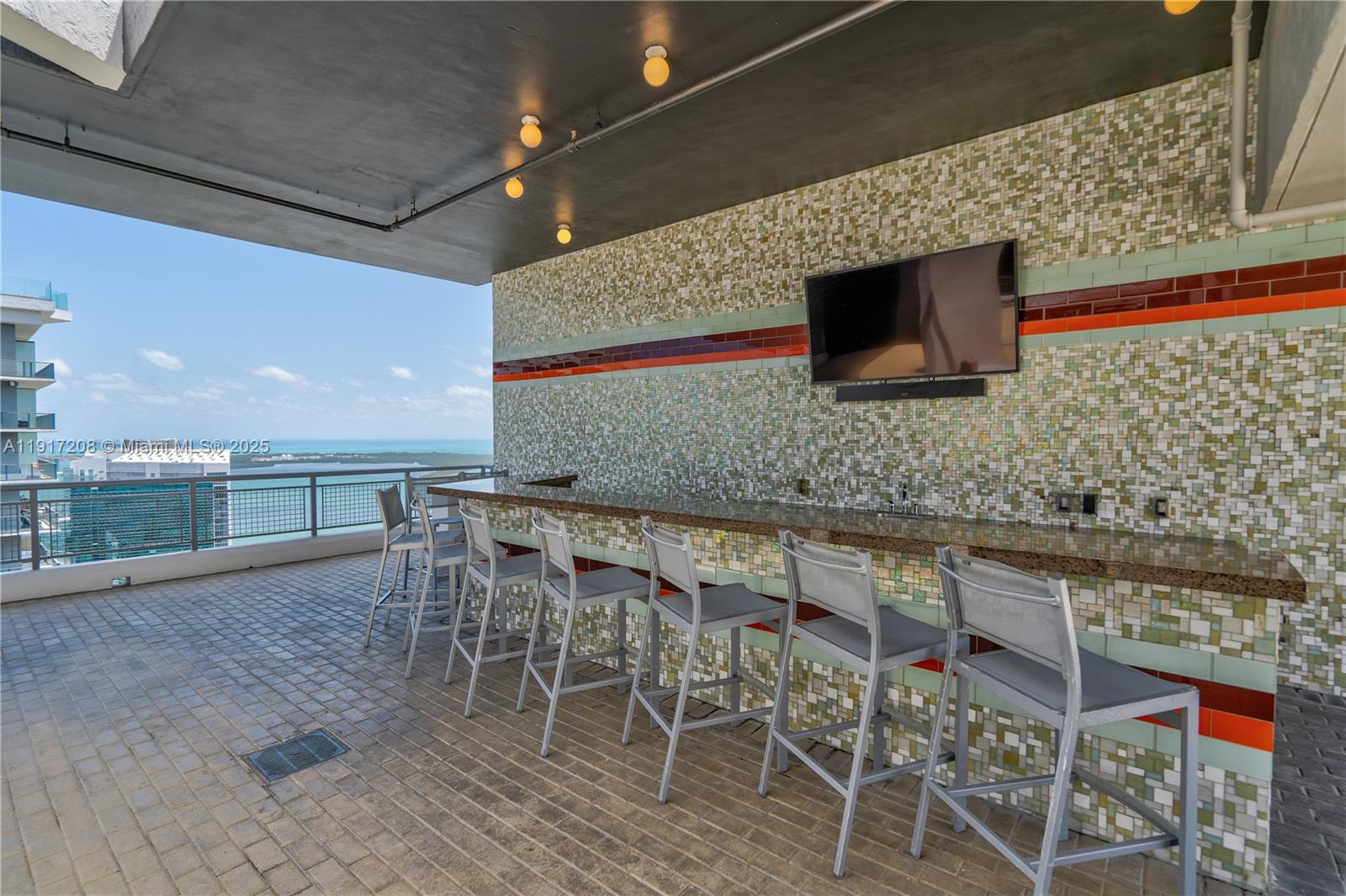 60 Southwest 13th Street, Unit 1400 Miami, FL 33130 - Photo 34 of 46 a dining room with a wooden table and chairs