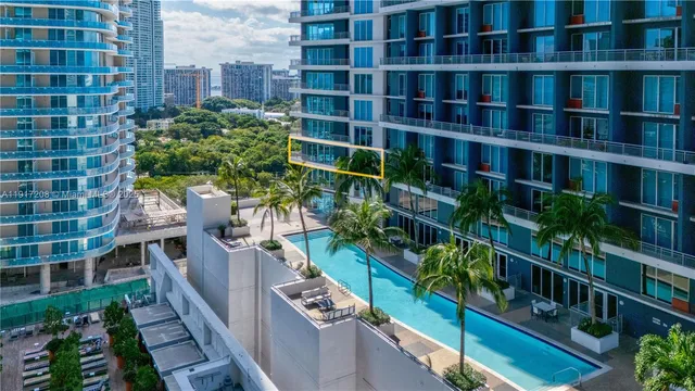 a bed sitting in a bedroom next to a large window