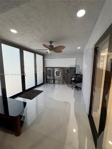 a view of a room with wooden floor and furniture