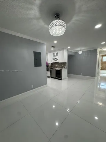 a view of an empty room with a cabinet