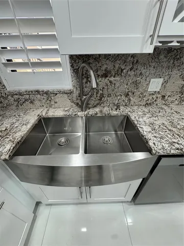 a view of kitchen with windows and refrigerator