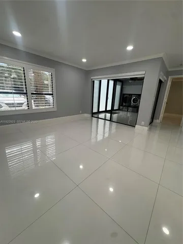 a room with furniture and kitchen view