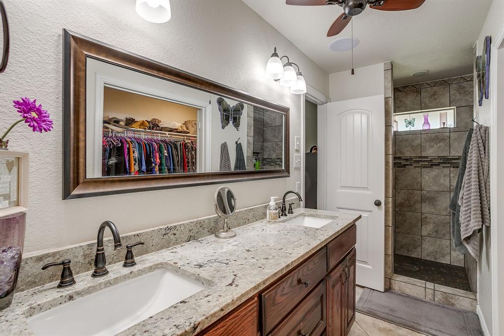 206 King George Way Ponder, TX 76259 - Photo 12 of 32 a bathroom with a granite countertop sink and a mirror