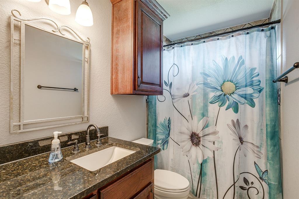 206 King George Way Ponder, TX 76259 - Photo 13 of 32 a bathroom with a granite countertop sink a toilet and a mirror