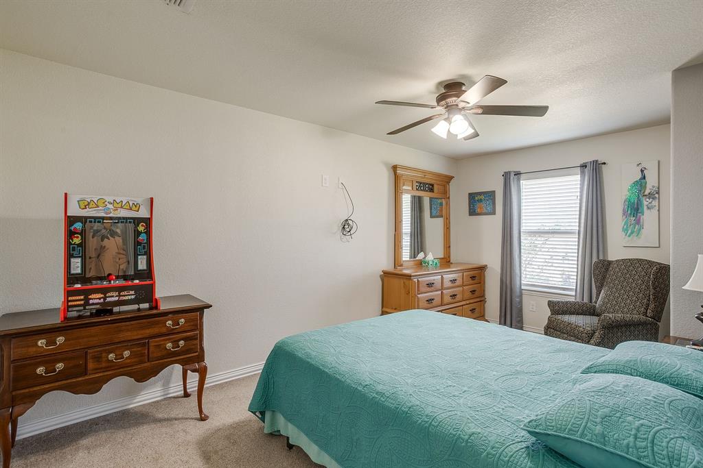 206 King George Way Ponder, TX 76259 - Photo 15 of 32 a bedroom with a bed dresser and a window