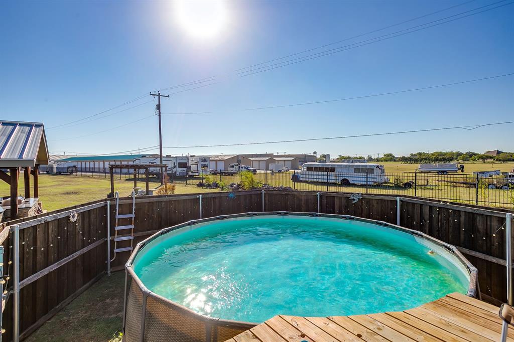 206 King George Way Ponder, TX 76259 - Photo 23 of 32 a view of a swimming pool with a lounge chairs
