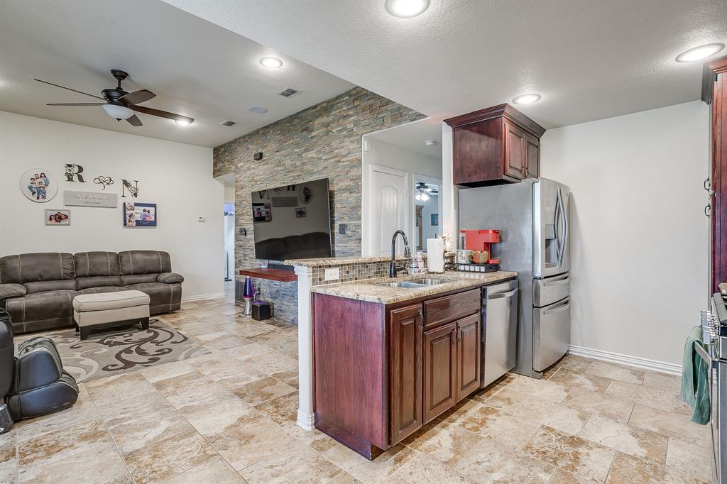 206 King George Way Ponder, TX 76259 - Photo 32 of 32 a kitchen with stainless steel appliances granite countertop a stove refrigerator and cabinets