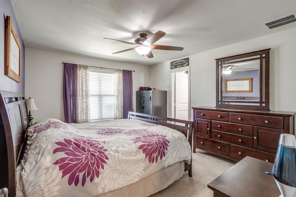 206 King George Way Ponder, TX 76259 - Photo 8 of 32 a bedroom with a bed and a dresser