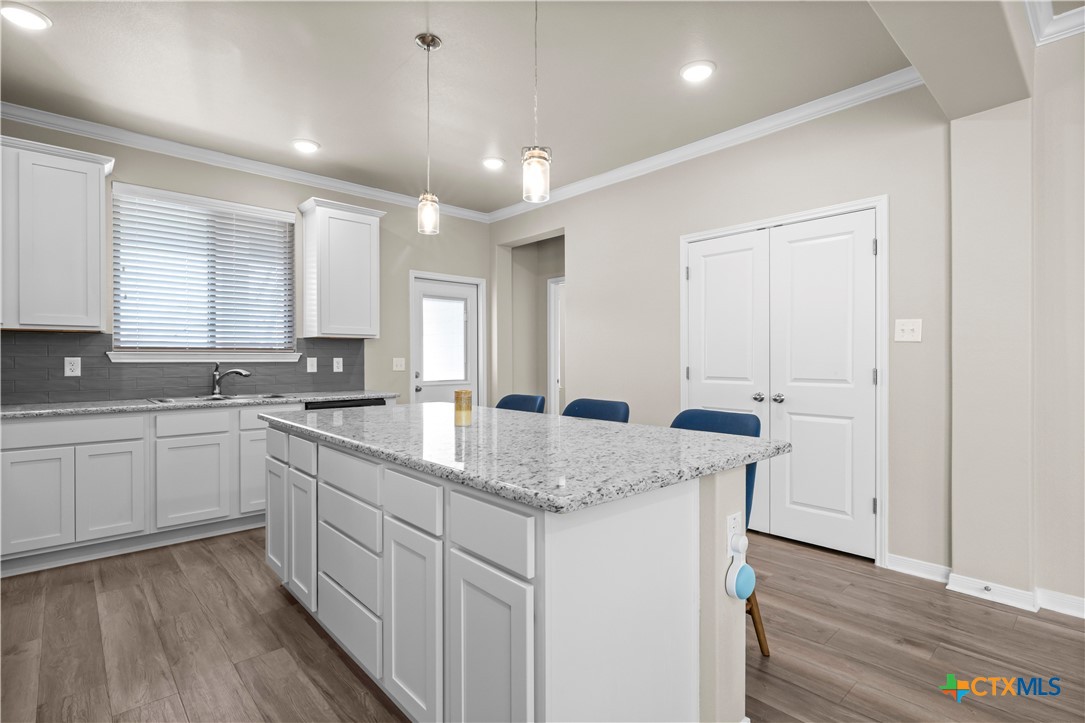 620 Ripplewood Drive Temple, TX 76502 - Photo 11 of 29 a kitchen with sink cabinets and wooden floor
