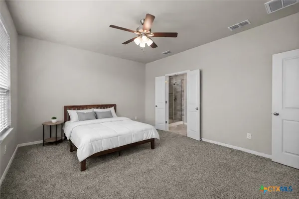 a bedroom with a bed and window