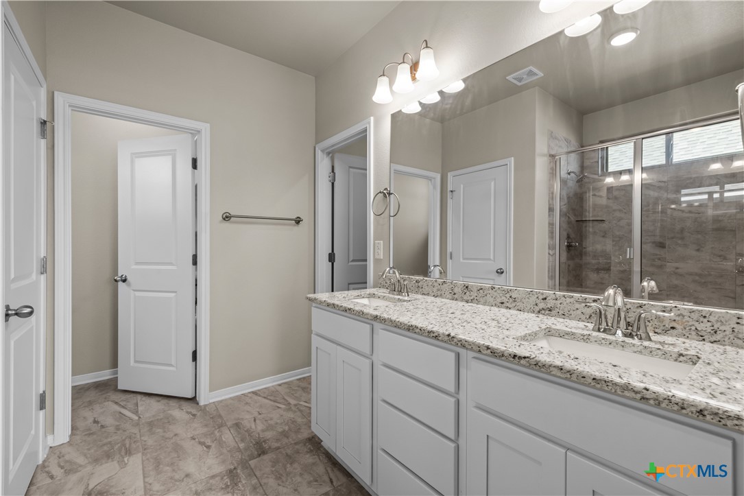 620 Ripplewood Drive Temple, TX 76502 - Photo 15 of 29 a bathroom with a granite countertop sink and a mirror