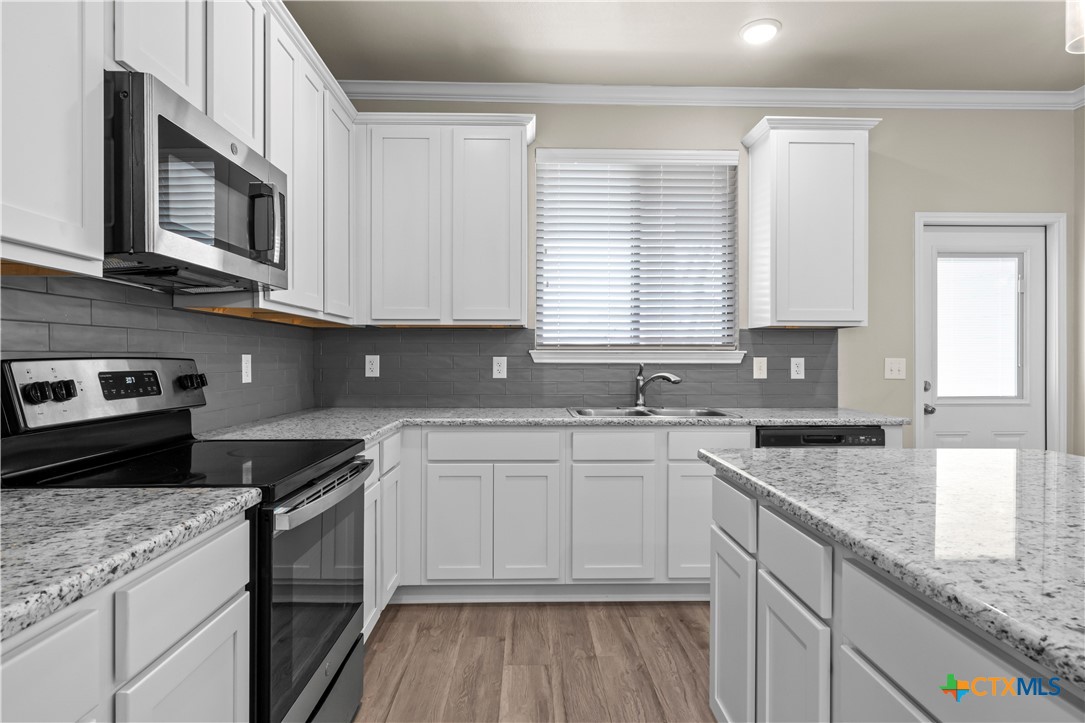 620 Ripplewood Drive Temple, TX 76502 - Photo 9 of 29 a kitchen with stainless steel appliances granite countertop a sink a stove a microwave and cabinets