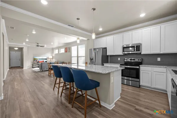 a kitchen with sink cabinets and wooden floor