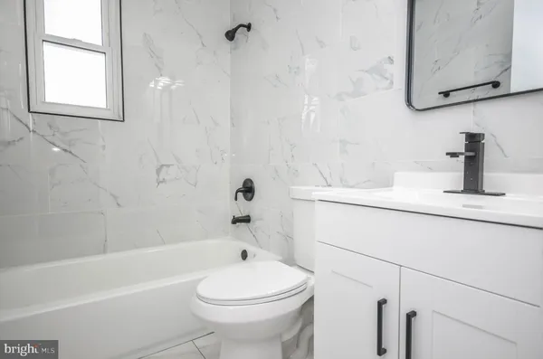 a bathroom with a sink a toilet and a bathtub