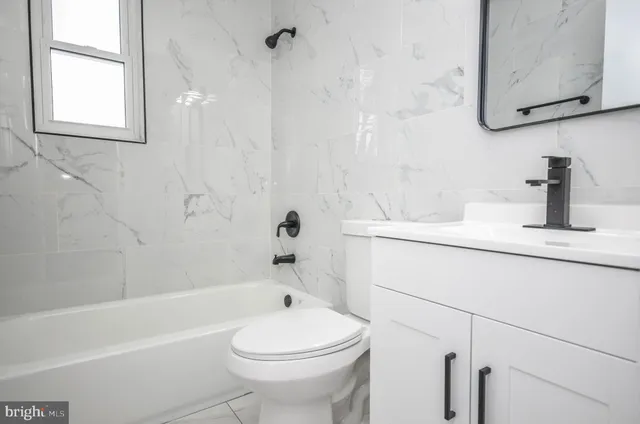 a bathroom with a sink a toilet and a bathtub