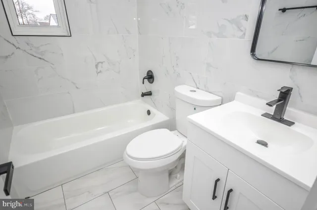a bathroom with a sink a toilet and bathtub