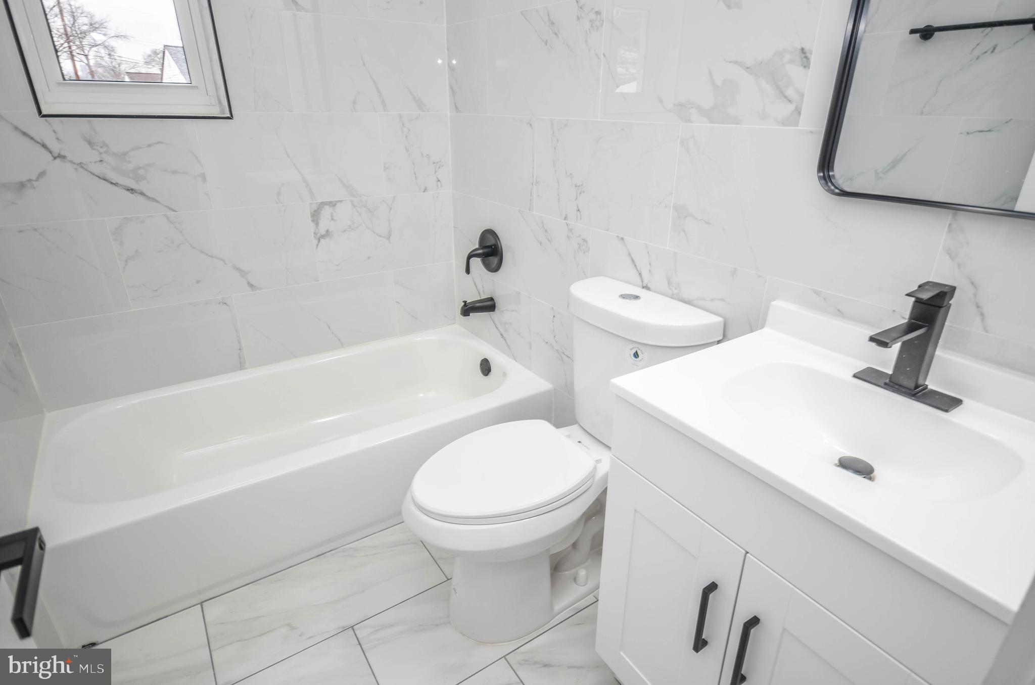 2110 Rolander Street Hyattsville, MD 20783 - Photo 21 of 33 a bathroom with a sink a toilet and bathtub