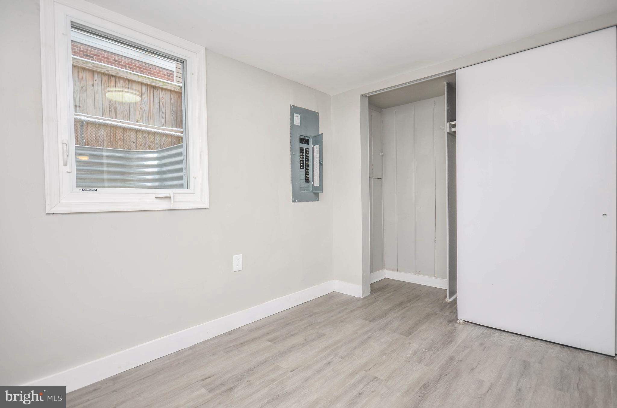 2110 Rolander Street Hyattsville, MD 20783 - Photo 27 of 33 a view of an empty room with wooden floor and a window