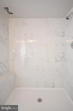 a bath tub sitting next to a white sink and vanity