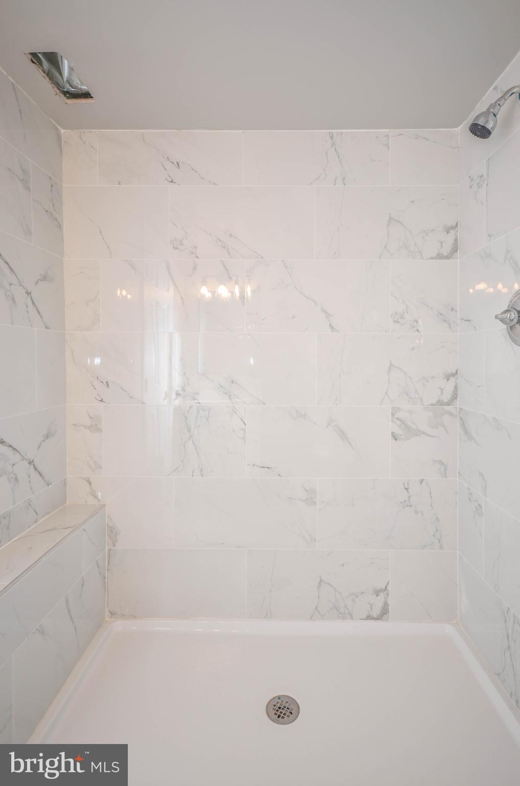 2110 Rolander Street Hyattsville, MD 20783 - Photo 29 of 33 a bath tub sitting next to a white sink and vanity