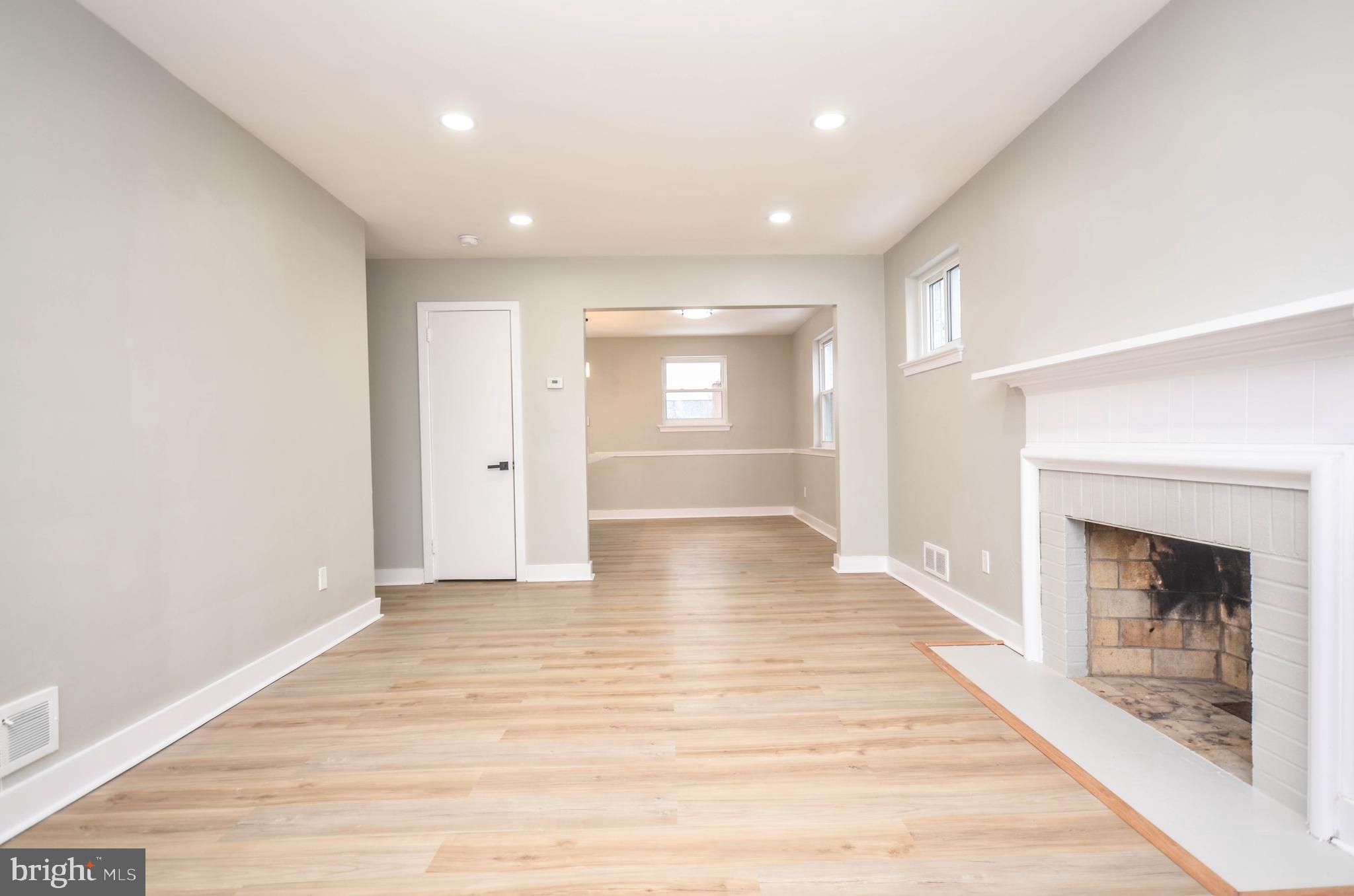 2110 Rolander Street Hyattsville, MD 20783 - Photo 4 of 33 a view of an empty room with wooden floor and a window