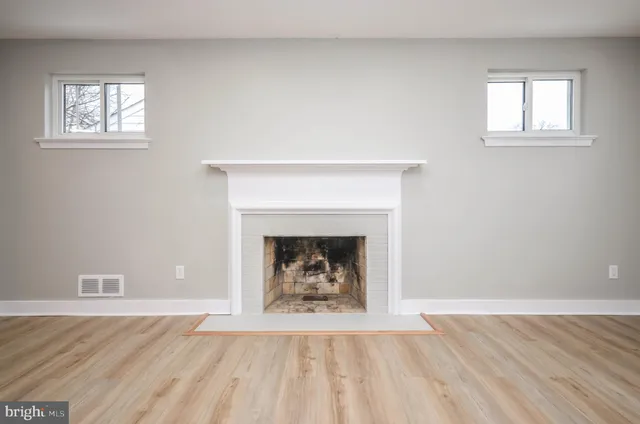 a living room with a fireplace and a fireplace
