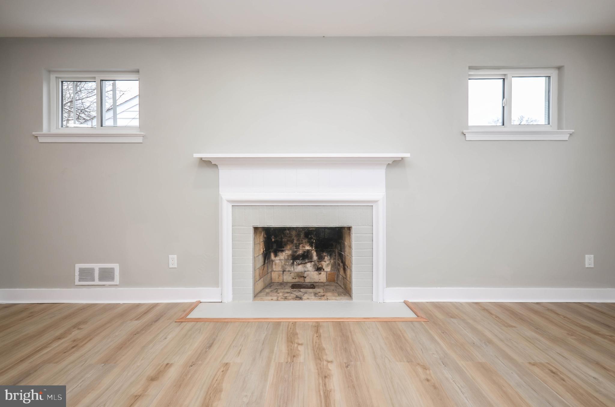 2110 Rolander Street Hyattsville, MD 20783 - Photo 5 of 33 a living room with a fireplace and a fireplace