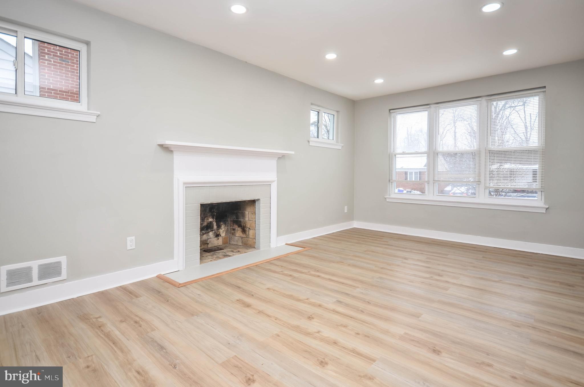 2110 Rolander Street Hyattsville, MD 20783 - Photo 6 of 33 a view of an empty room with a window and wooden floor