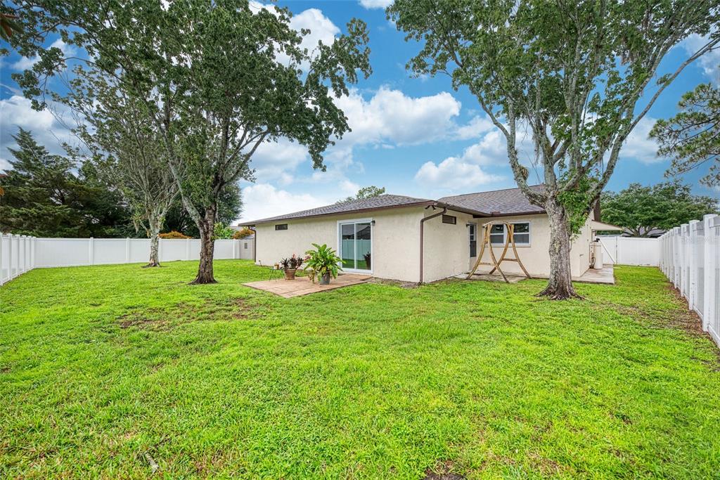 1330 Georgetowne Circle Sarasota, FL 34232 - Photo 37 of 46 a front view of a house with a yard and trees