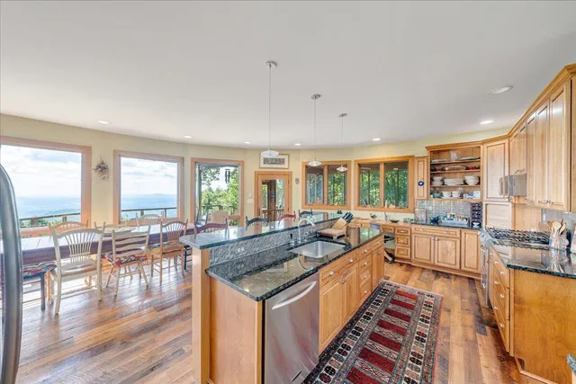 a kitchen with granite countertop a large window and a sink