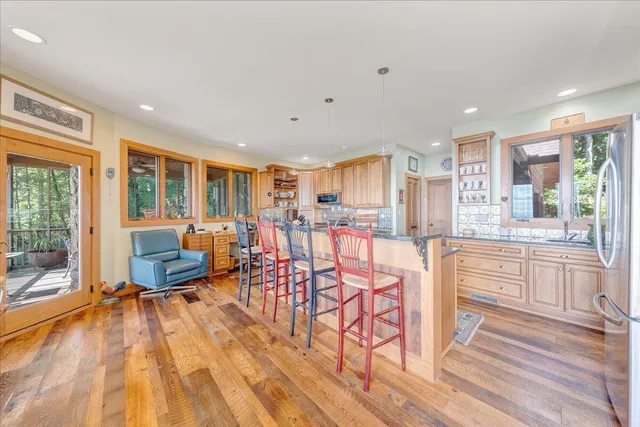 a kitchen with stainless steel appliances granite countertop a refrigerator and a stove