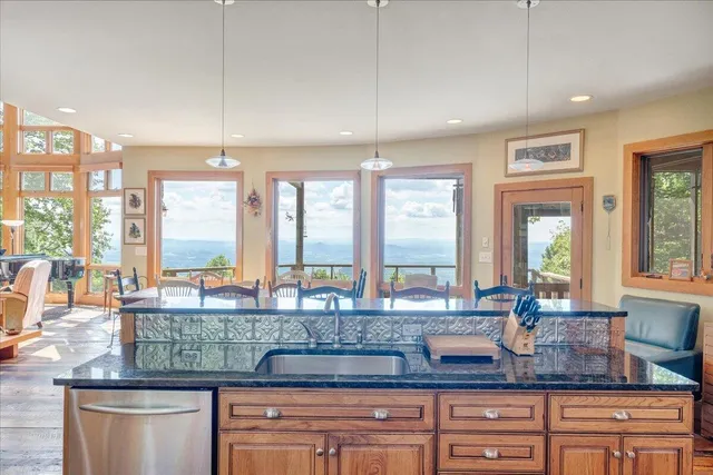 a view of a dining room with furniture large windows and wooden floor