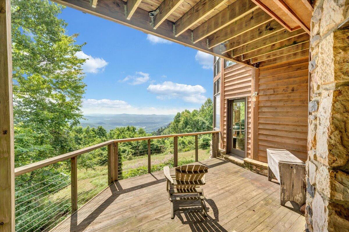 490 Lookout Ridge Lane Copper Hill, VA 24079 - Photo 25 of 69 a view of a balcony with chair and wooden floor