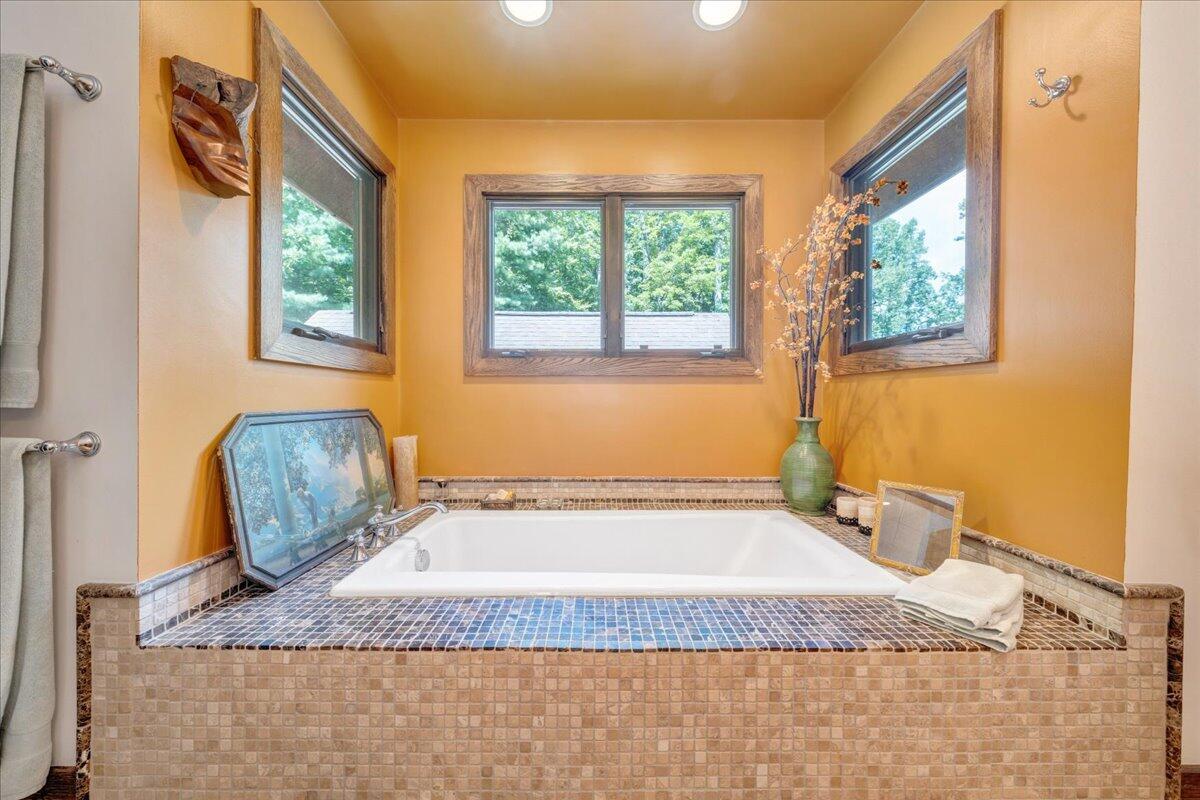 490 Lookout Ridge Lane Copper Hill, VA 24079 - Photo 33 of 69 a bathroom with a granite countertop sink and a bathtub