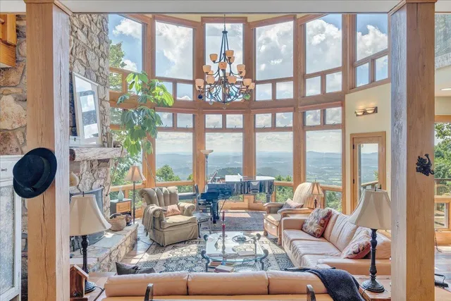 a living room with furniture and a floor to ceiling windows