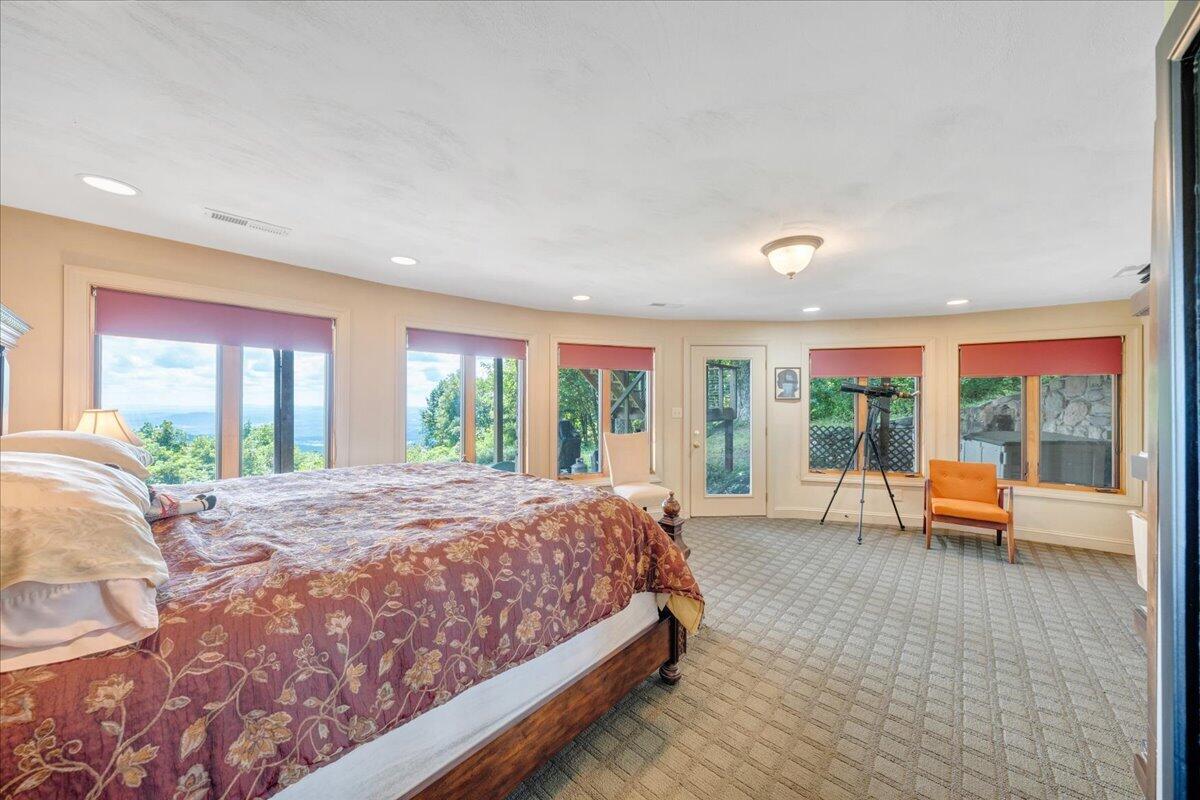 490 Lookout Ridge Lane Copper Hill, VA 24079 - Photo 47 of 69 a bed sitting in a spacious bedroom next to a large window